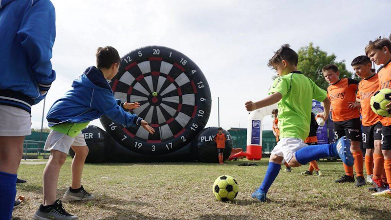 Children playing football darts at the Riviera Easter Cup tournament