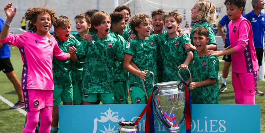 Young footballers celebrate winning at the Villa de Peguera Tournament