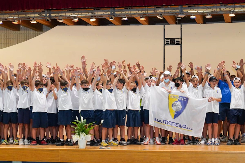 Youth football team with raised hands at Toscana Youth Festival