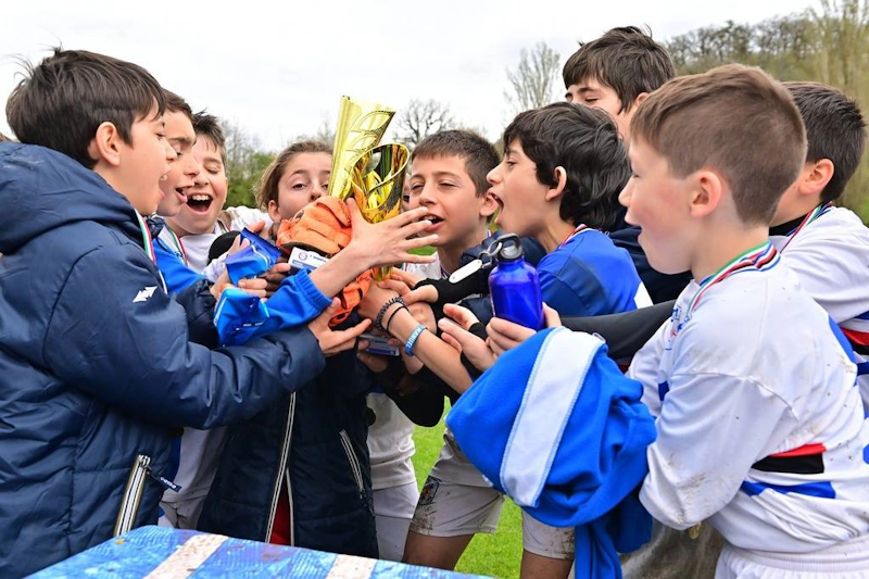 Young footballers celebrate a win with a trophy at the Umbria Cup