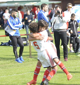 Children in football kits hugging at U10 Raddatz Immobilien Cup tournament