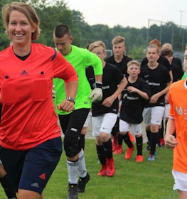 Football teams making their way onto the pitch at Oranje Cup event